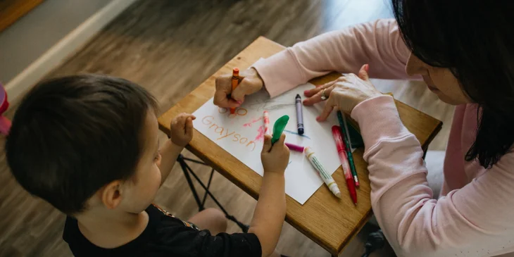 Caregiver helping child with activity